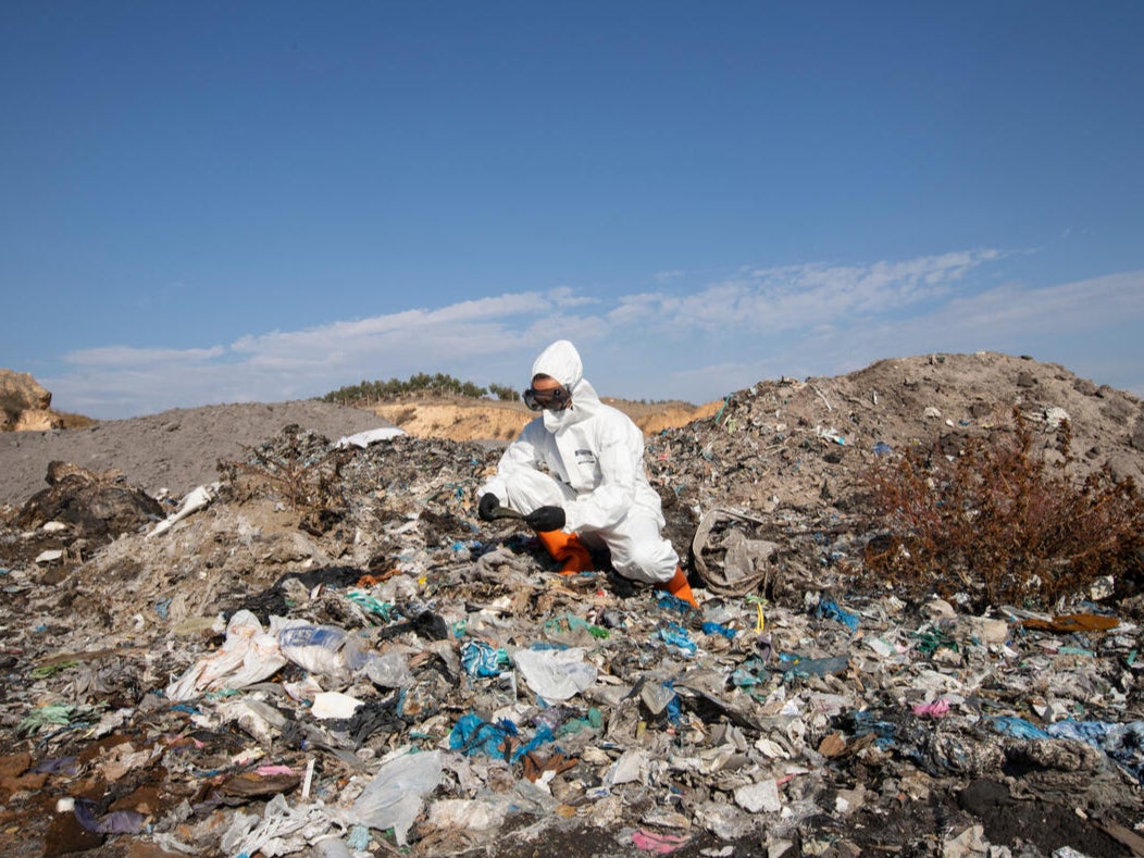 A Greenpeace campaigner investigates a waste pile in Adana