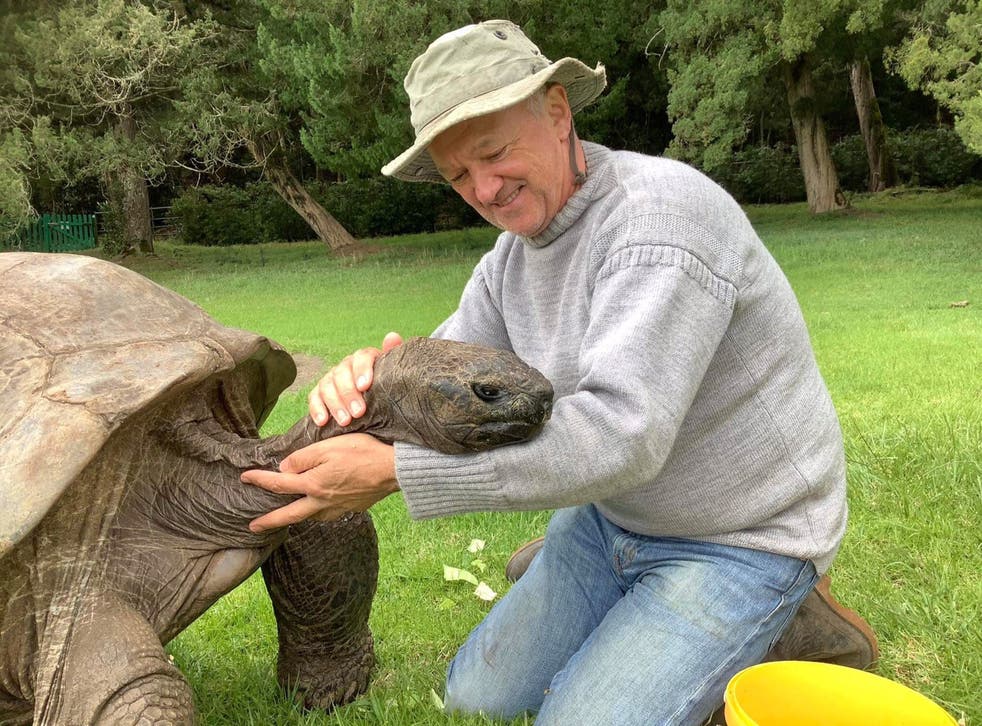 <p>Jonathan the tortoise, 190, and his caretaker, Joe Hollins, 64, on St Helena island</p>