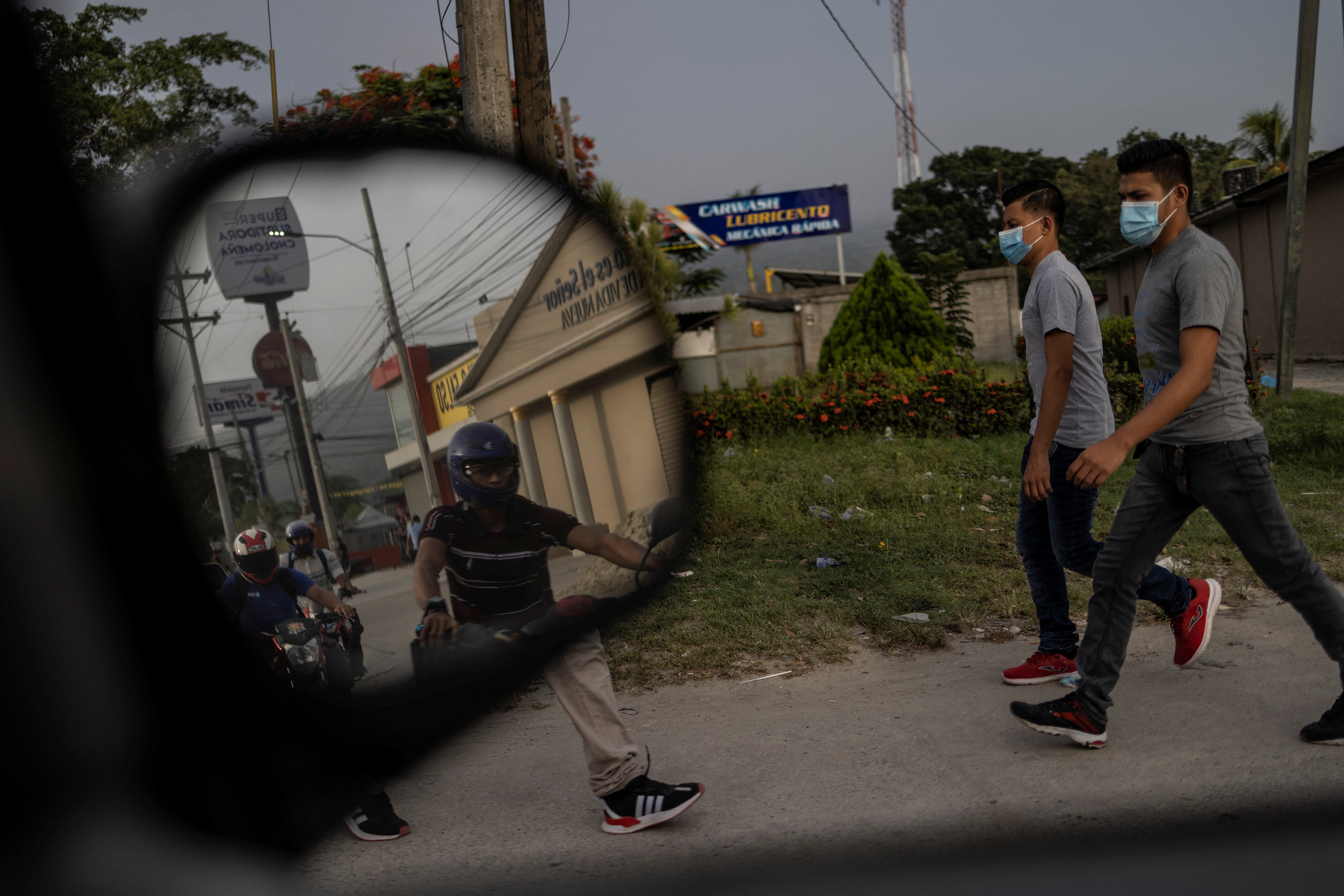 Local residents walk around an industrial area of northwest Honduras