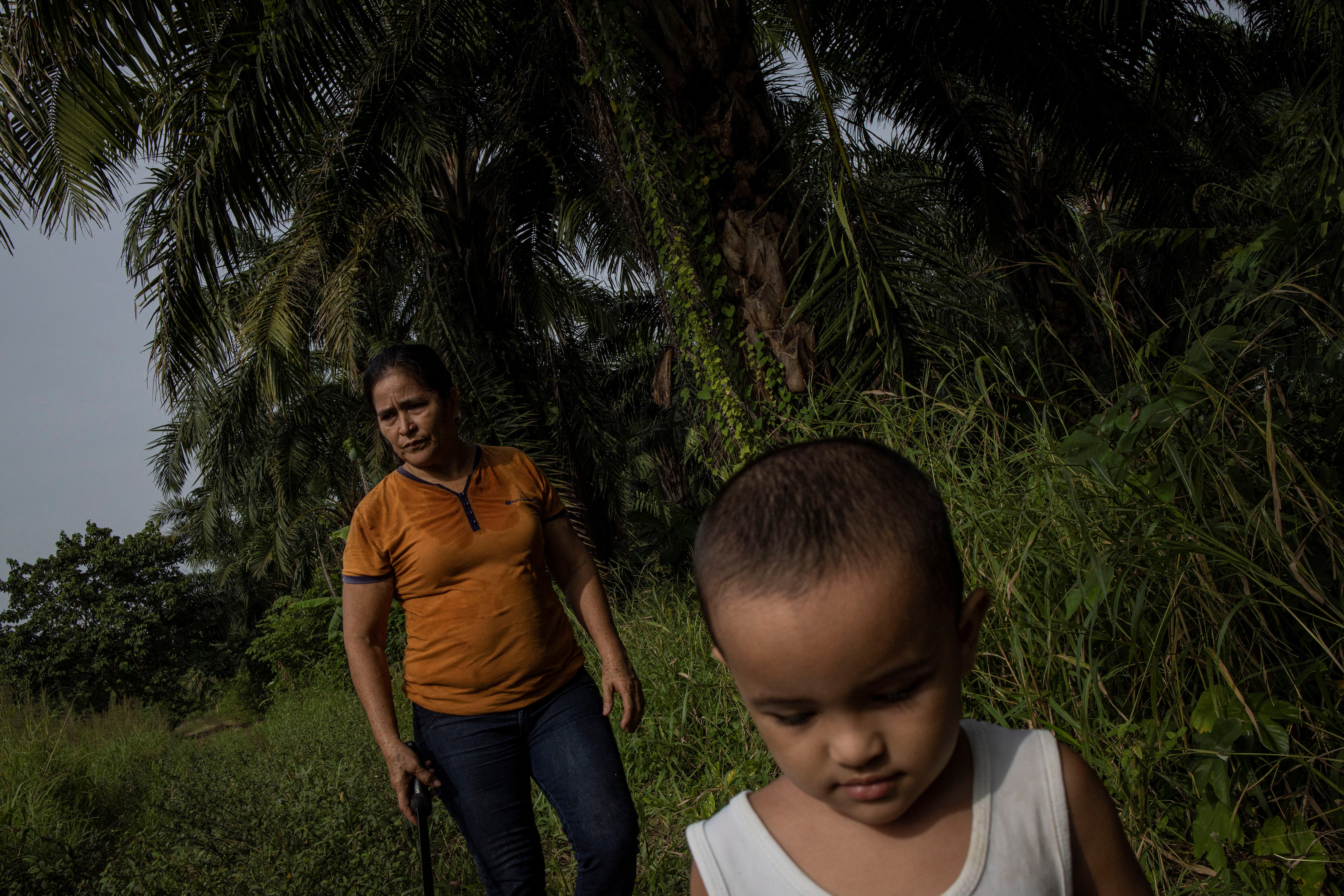 Maria, accompanied by her grandson Aron, arrives to work at a banana plantation in Honduras