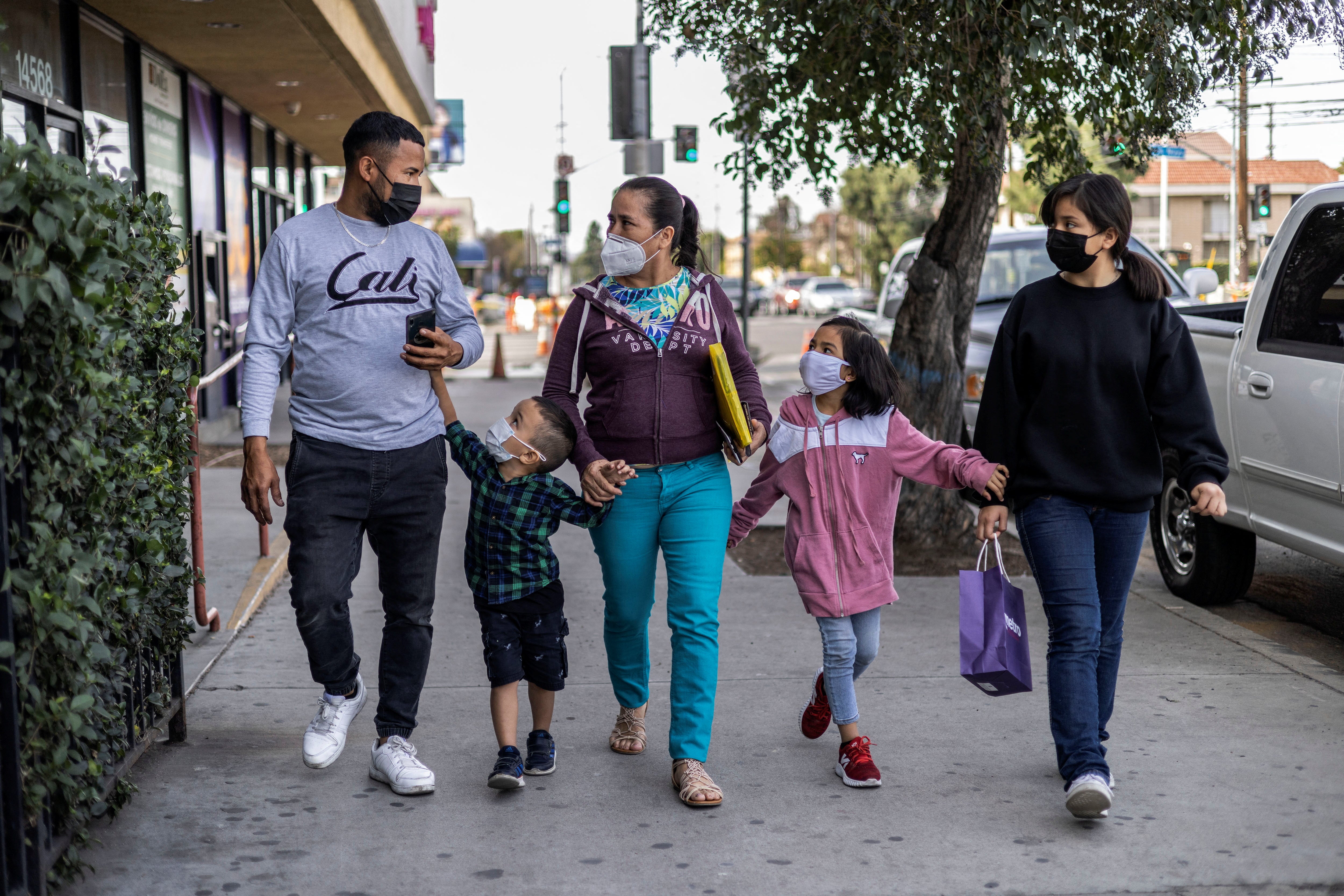 Maria walks with Maynor, Aron, Nicole and Michelle along a street in Los Angeles