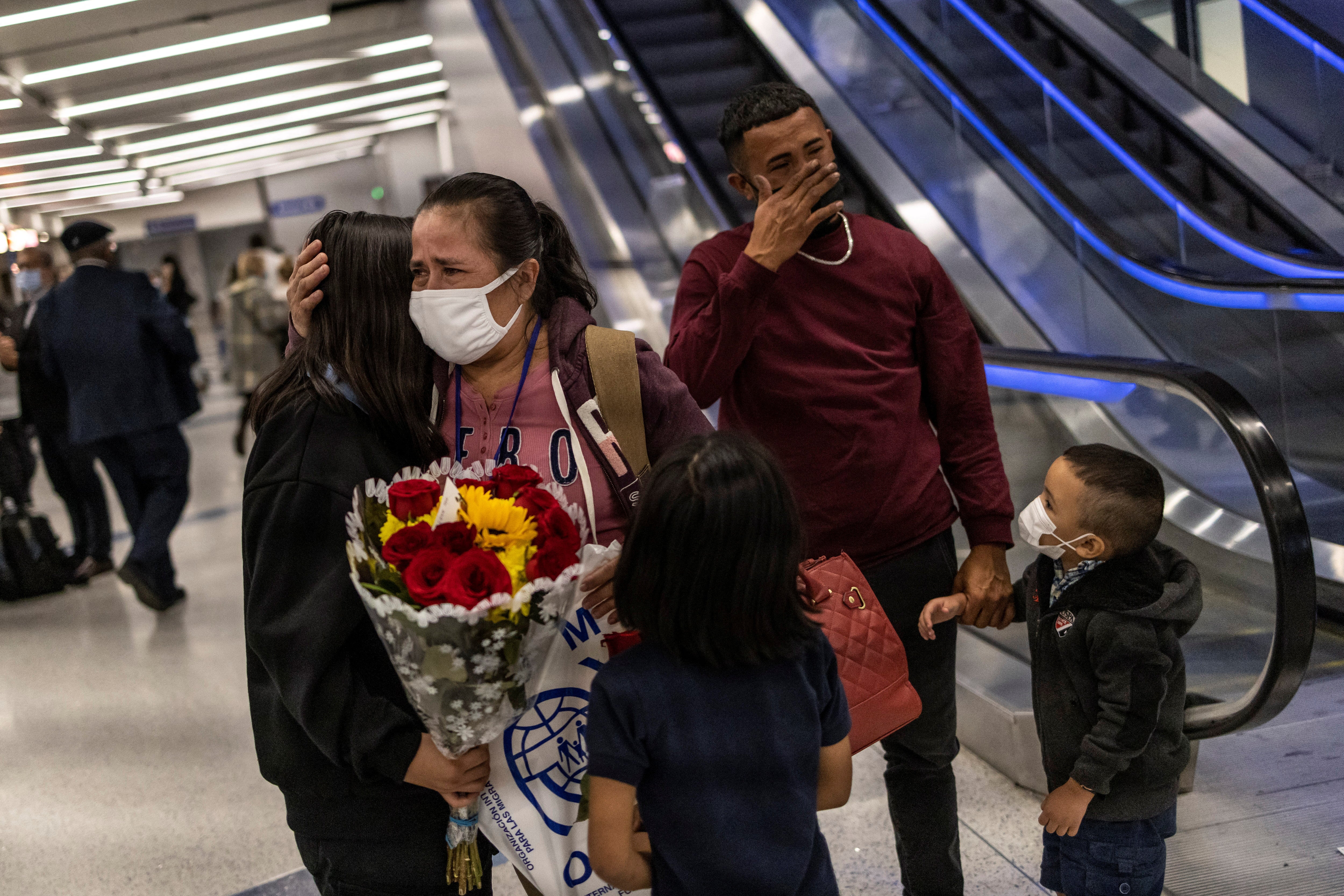 Maria Hernandez (centre) hugs her daughter Michelle, while her son Maynor (second from right) is overcome with emotion during their reunion at Los Angeles international airport