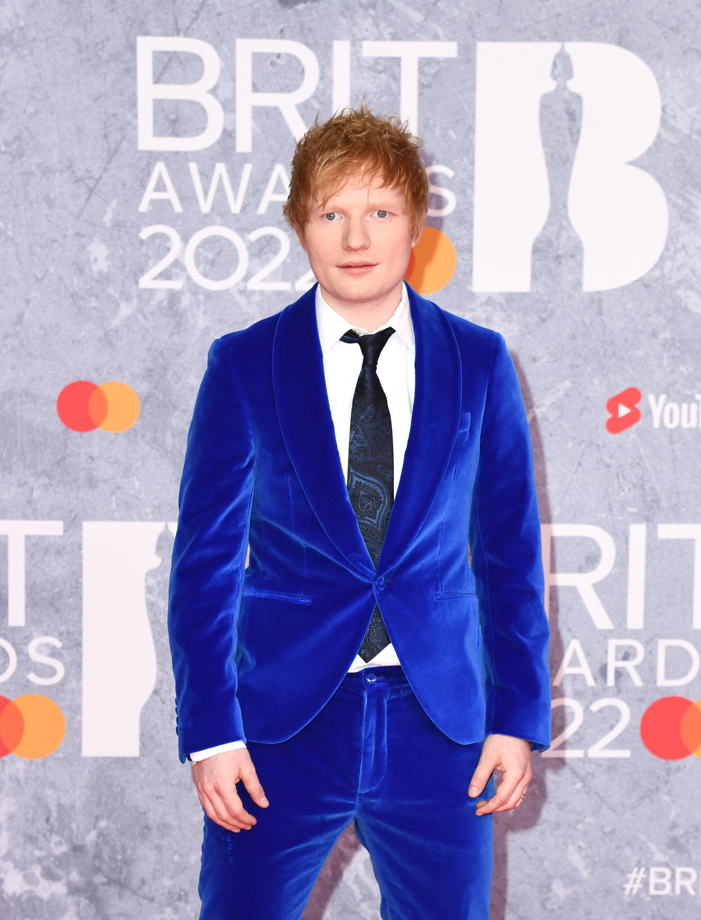 The musician, who is performing at the Brits, wore an electric blue velvet suit custom-made for him by Etro for the occasion. He paired the look with a paisley print tie,