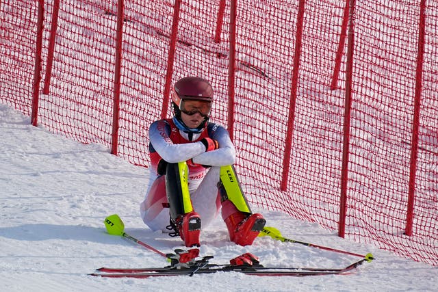 <p>Mikaela Shiffrin, of the United States sits on the side of the course after skiing out in the first run of the women's slalom</p>