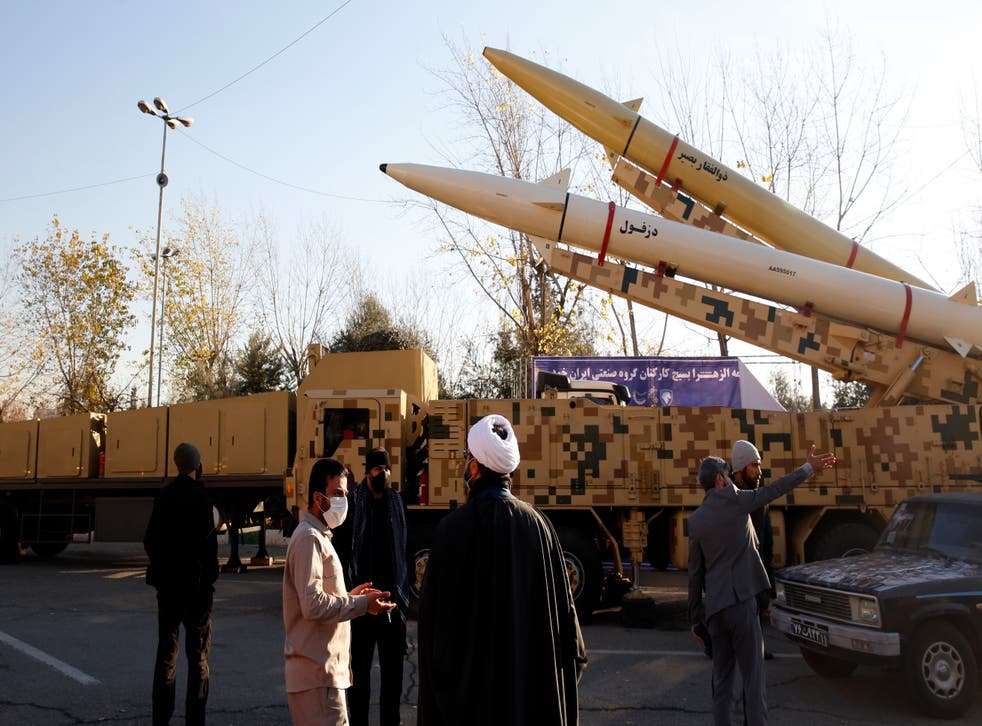 <p>Iranian officials gather around missiles displayed at Mosallah Mosque in Tehran, Iran, 7 January 2022</p>