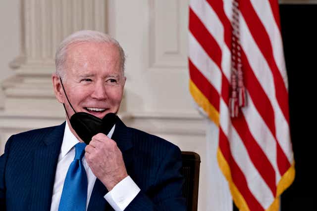 <p>President Joe Biden pulls down his mask to speak while meeting with chief executive officers of electric utilities companies, in the State Dining Room of the White House in Washington, DC on Wednesday</p>