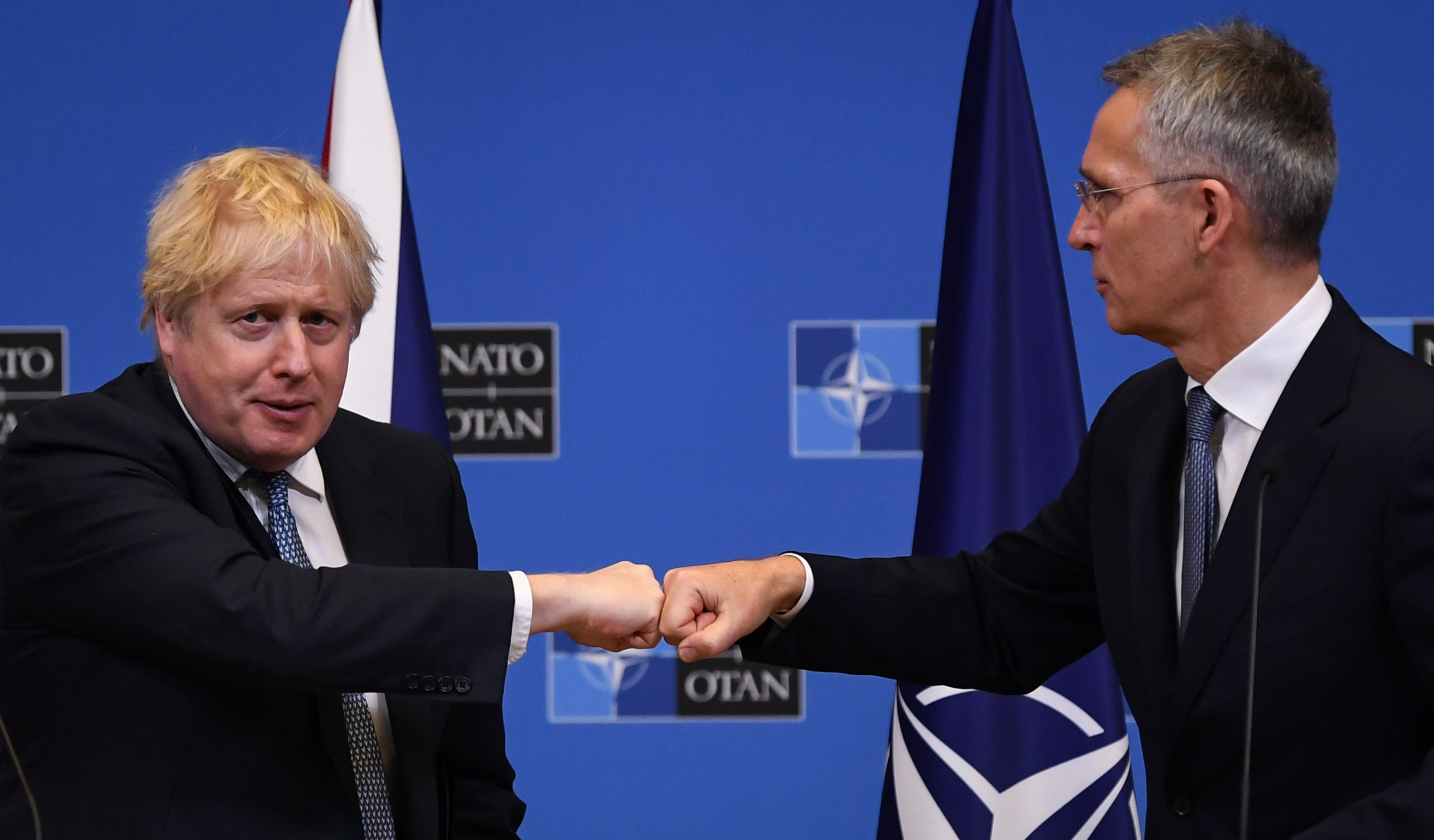 Boris Johnson (left) fist bumps Nato secretary general Jens Stoltenberg in Brussels (Daniel Leal/PA)