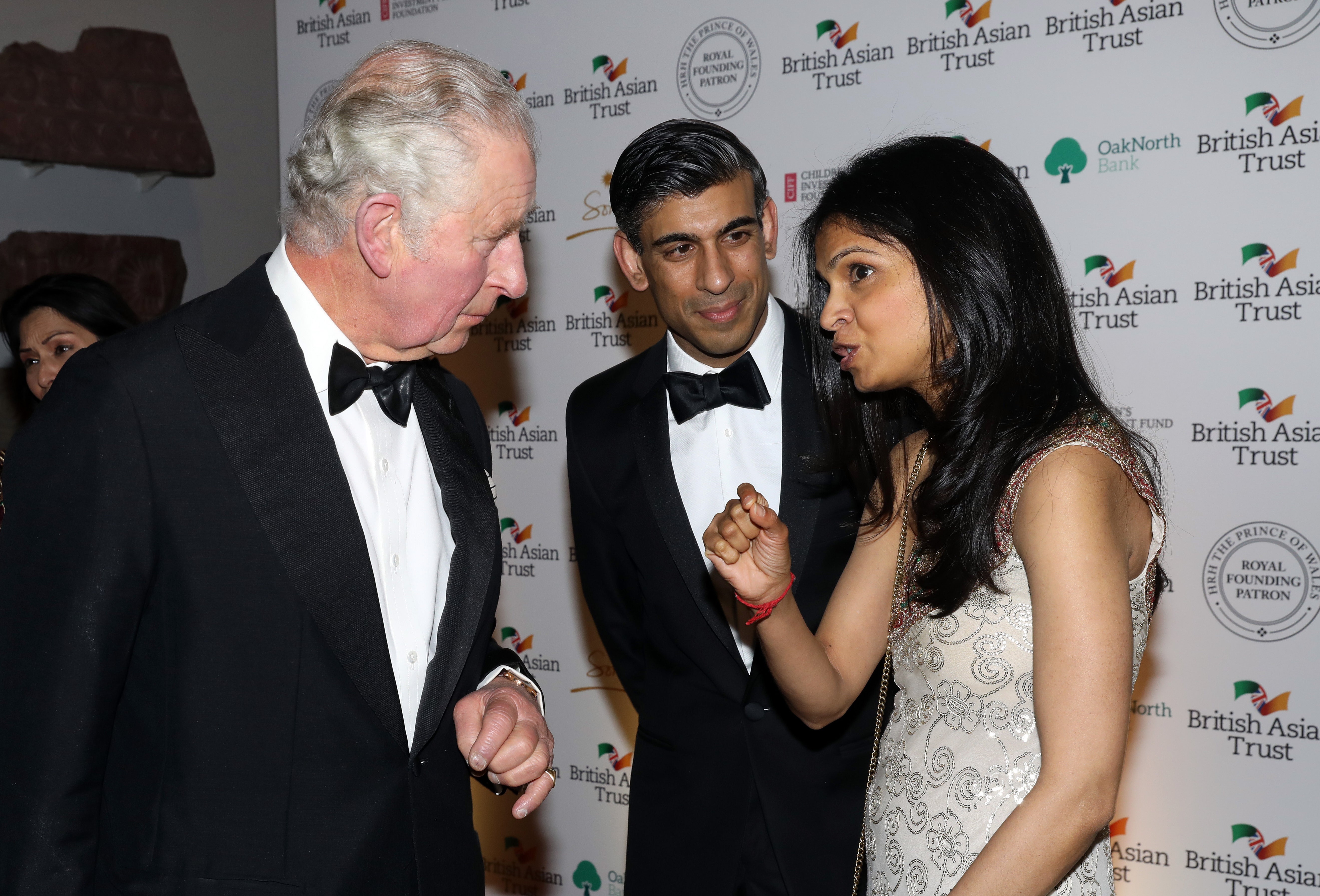The Prince of Wales speaks to Chancellor Rishi Sunak and his wife Akshata Murthy at the British Asian Trust reception (PA)