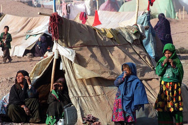 <p>Afghan refugees stay outside their makeshift camps to feel the sun’s heat in Jalozai refugee camp near Peshawar</p>