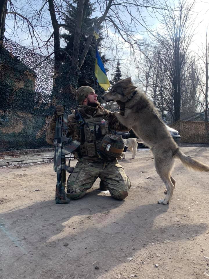Dmytro Kotsyubaylo with the unit’s wolf, who was raised from a cub