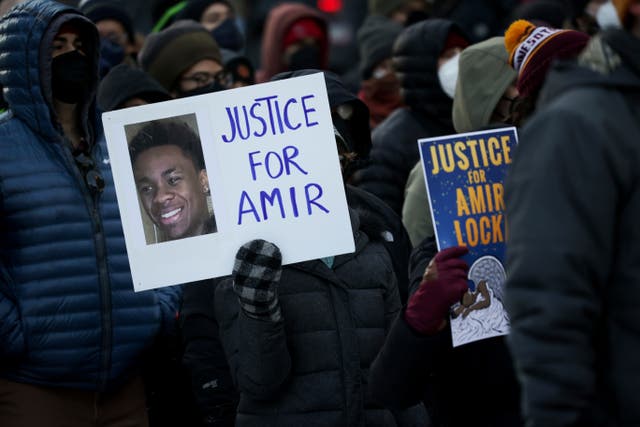 <p>A protester holds a sign demanding justice for Amir Locke at a rally on Saturday, Feb. 5, 2022, in Minneapolis. </p>