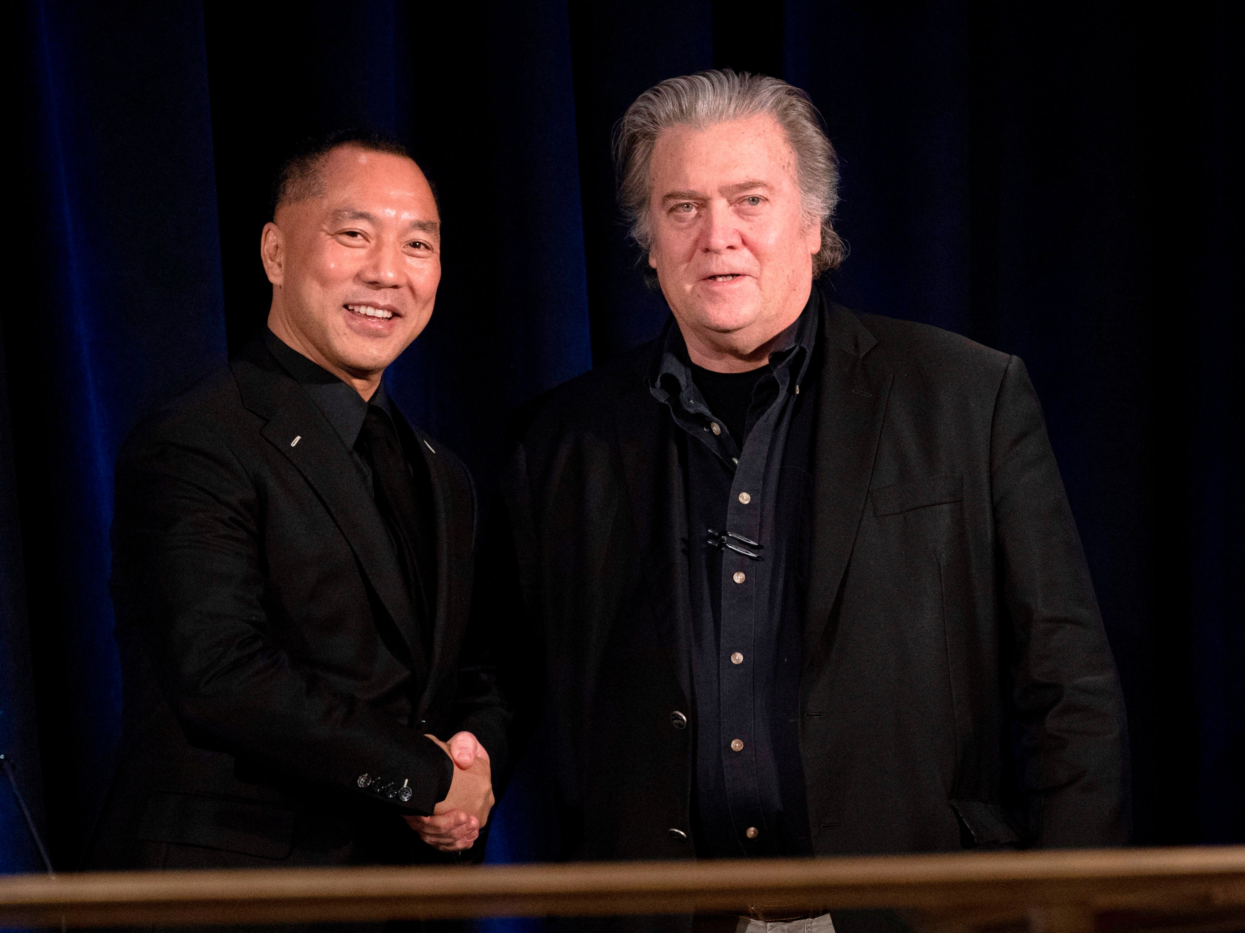 Former White House Chief Strategist Steve Bannon (R) greets fugitive Chinese billionaire Guo Wengui before introducing him at a news conference on November 20, 2018 in New York