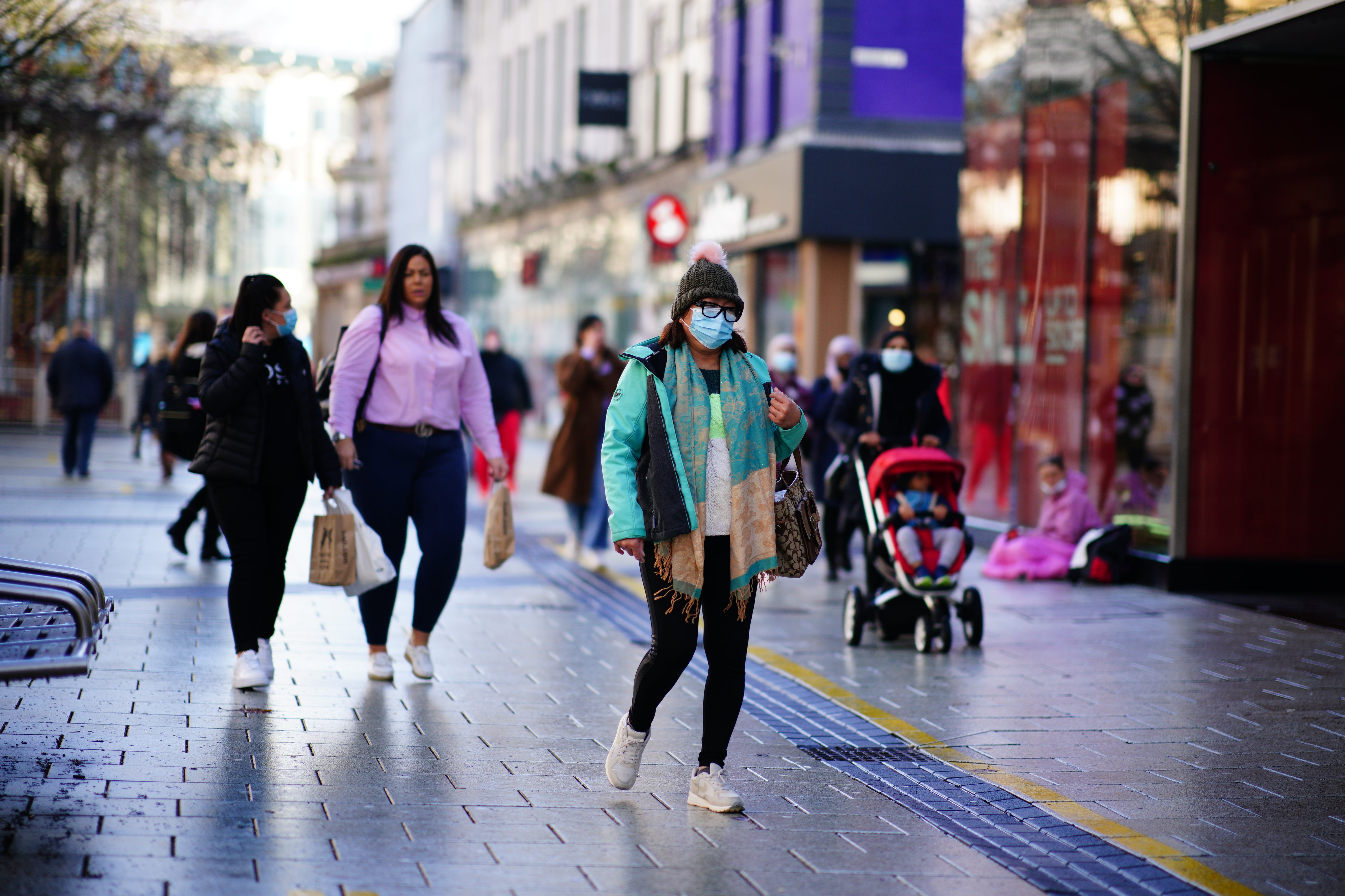 Shoppers walk through the centre of Cardiff, Wales (Ben Birchall/PA)
