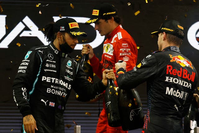 <p>Carlos Sainz, background, was on the podium in Abu Dhabi</p>