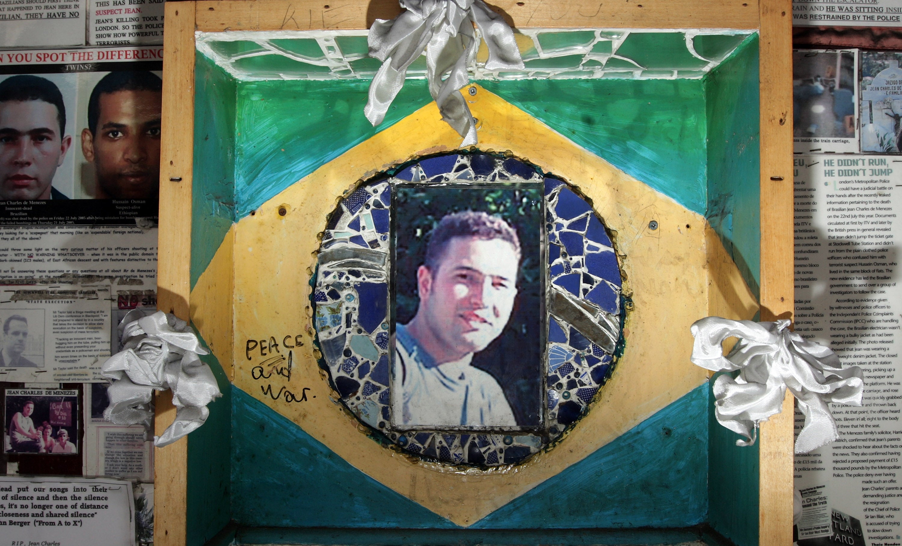 A memorial made up of press cuttings and photographs outside Stockwell Tube station to honor Jean Charles de Menezes