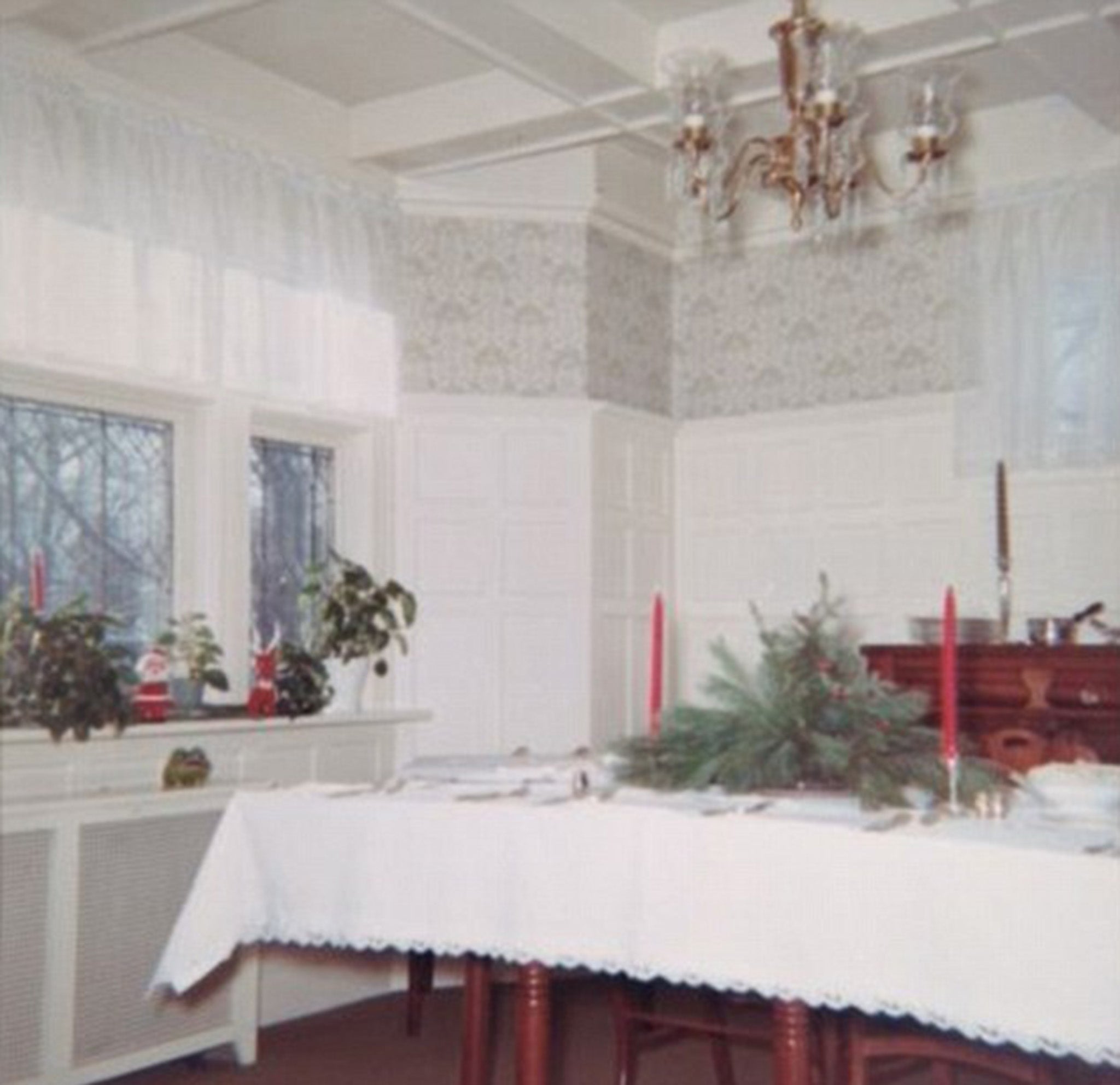 The stately home, which has six bedrooms, is nestled on a quite street about 28 miles from Manhattan; its high-ceilinged dining room is pictured in this Christmas photo taken by a previous owner