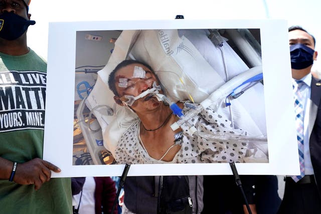 <p>People hold a photo of  61-year old Yao Pan Ma who was was attacked from behind, pushed to the ground, and repeatedly kicked in Harlem</p>