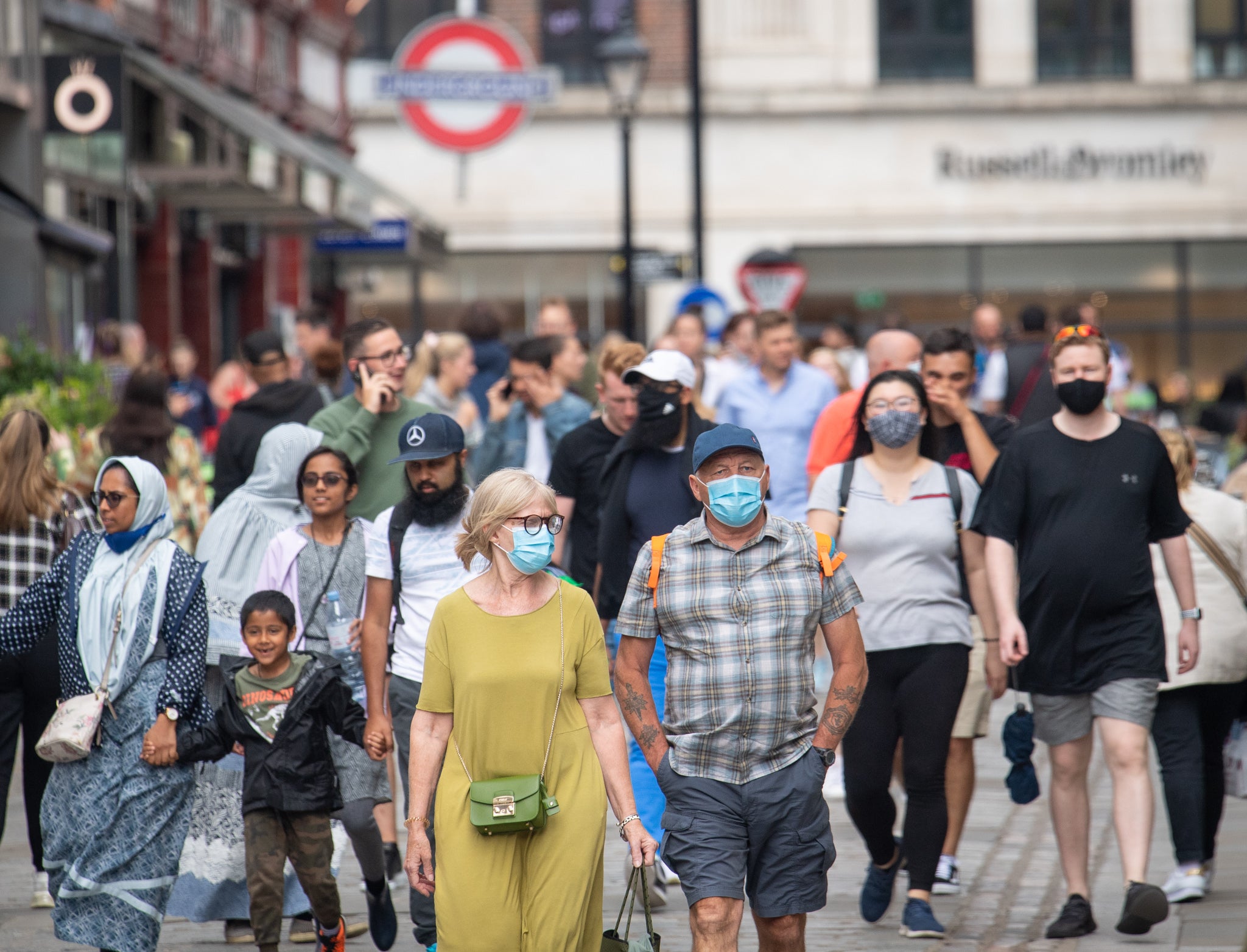 People wearing face masks among crowds of pedestrians in Covent Garden, London. (PA)
