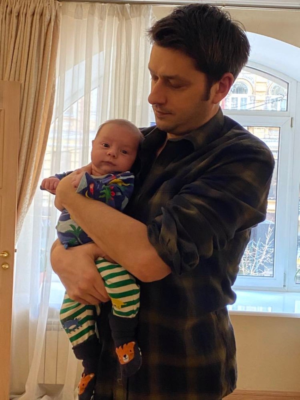 Ben Garratt and his wife moved to Ukraine in December to oversee official paperwork for their surrogate-born baby, Raphael (Ben Garratt/AP)
