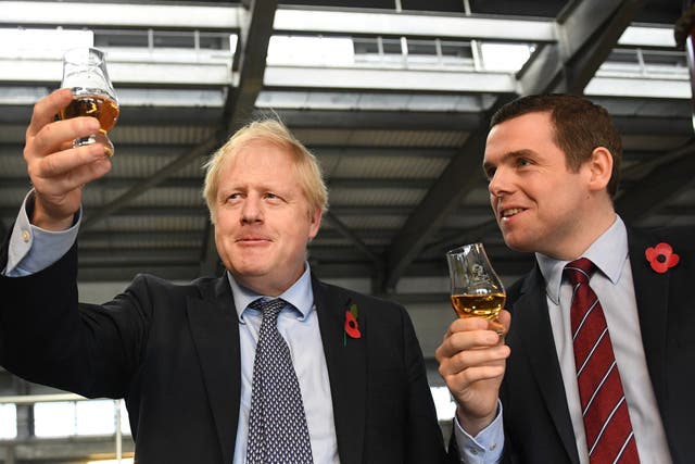 Boris Johnson with Douglas Ross on a distillery tour during the 2019 general election campaign (PA)