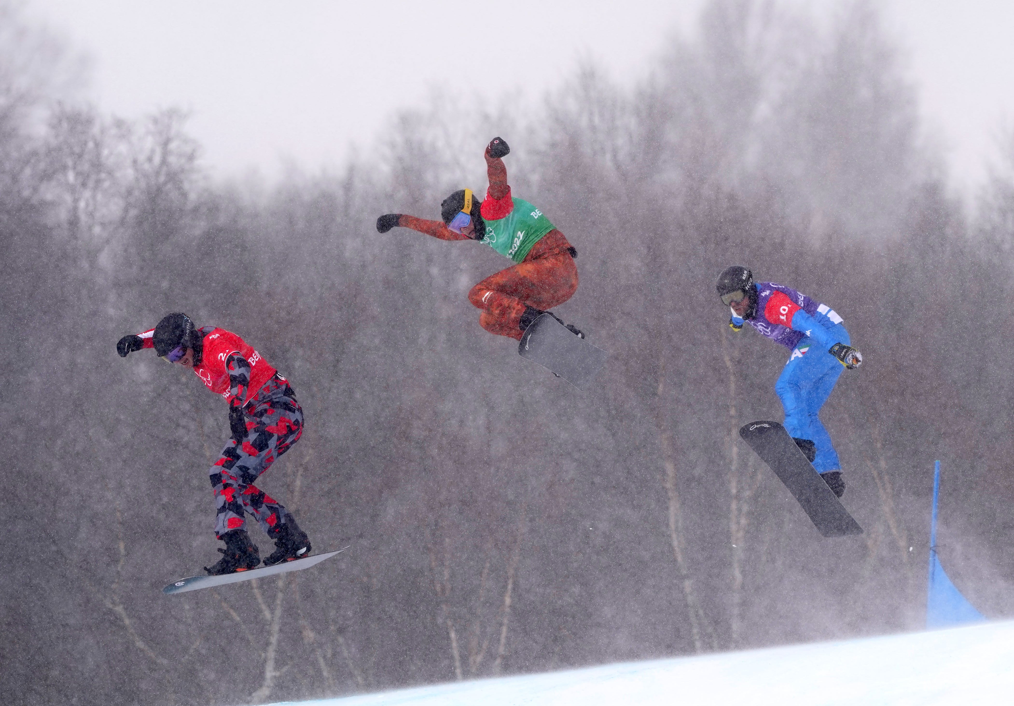 Austria’s Pia Zerkhold, Canada’s Tess Critchlow and Italy’s Caterina Carpano (left-right) competing in the mixed team snowboard cross (Andrew Milligan/PA)