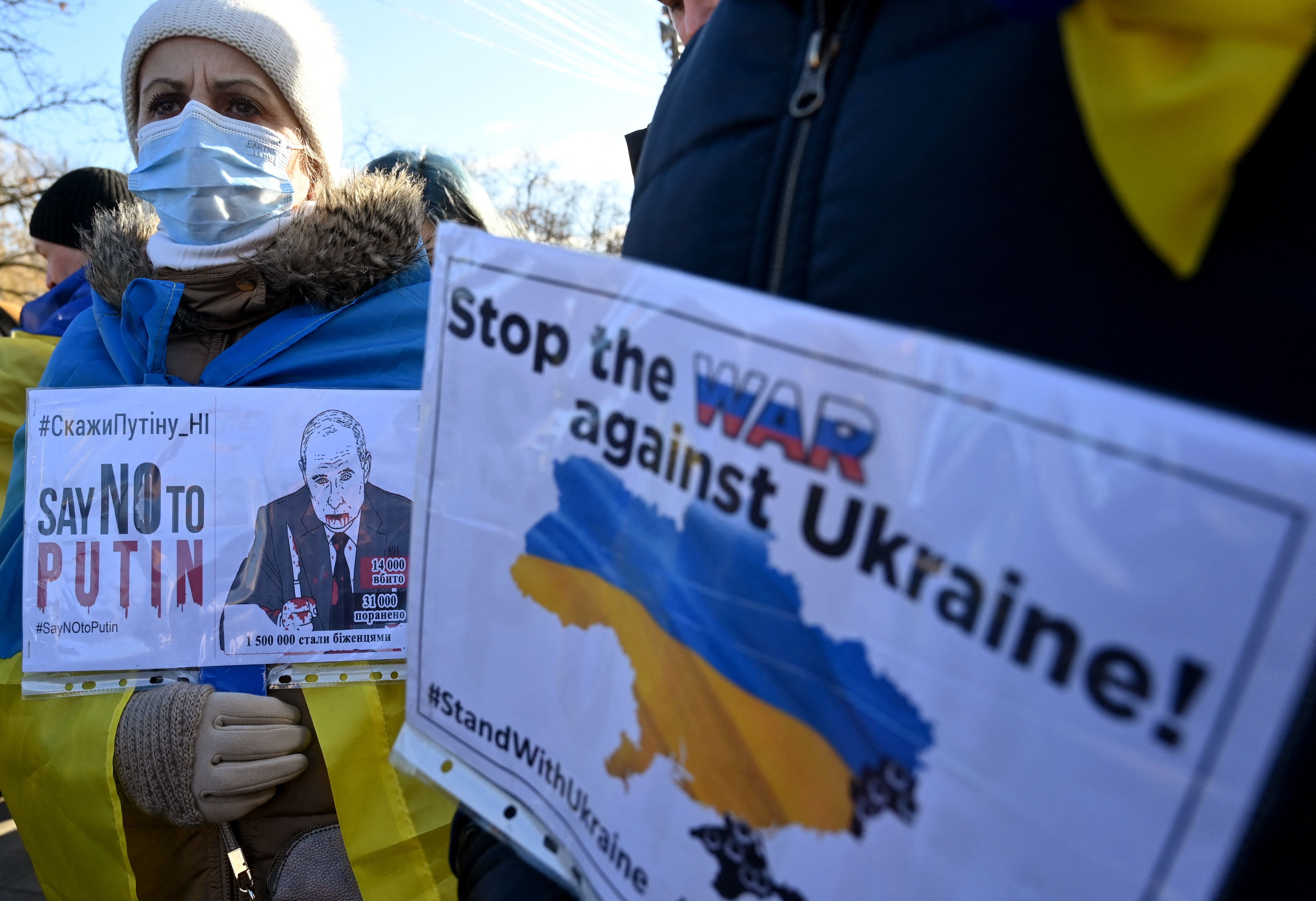 Demonstrators carry placards during the rally on Saturday