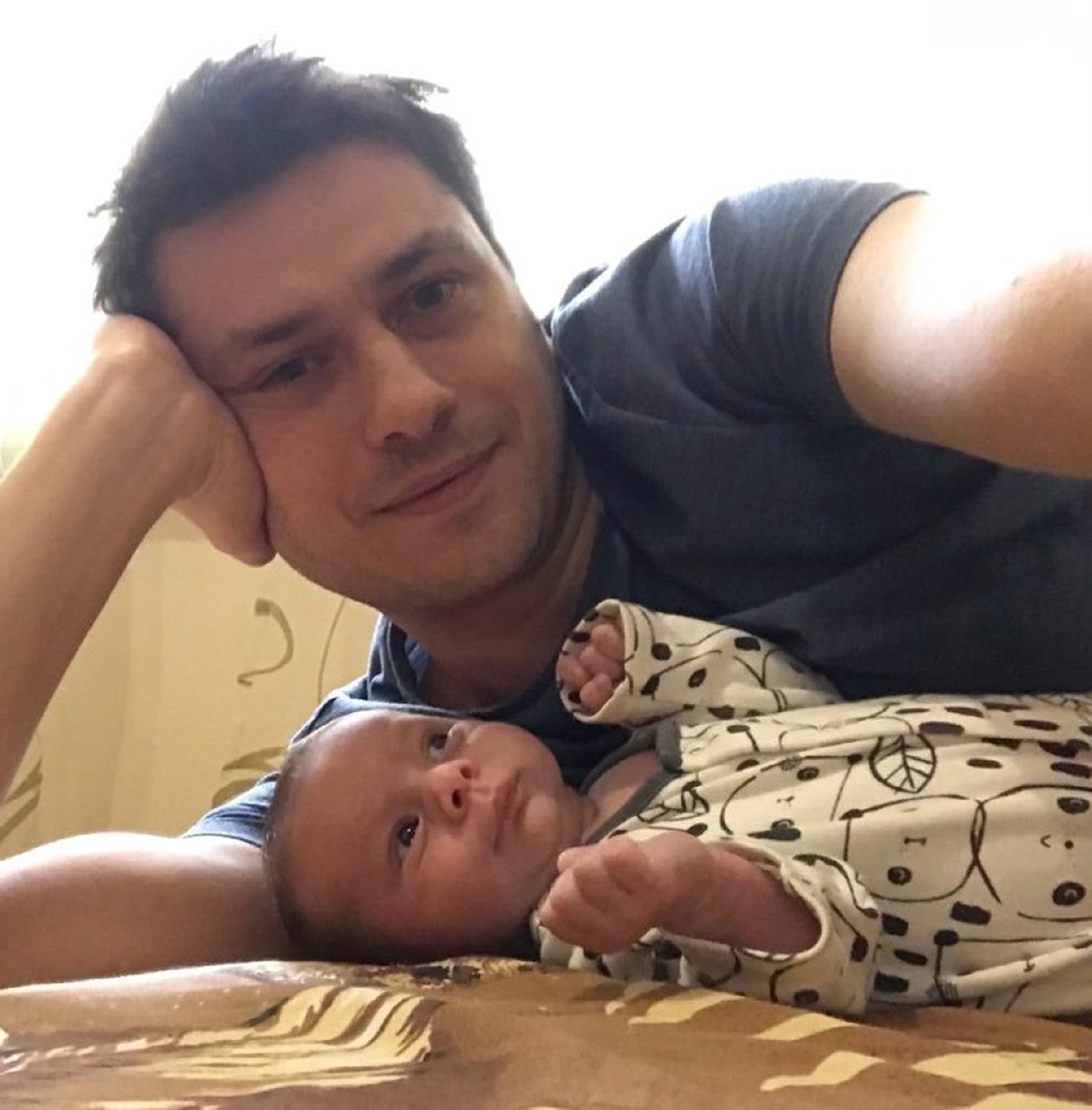 Ben Garratt, from north London, with baby Raphael. Garratt and his wife, Alice, are livinsg in Kiev and cannot return until their baby’s paperwork is completed