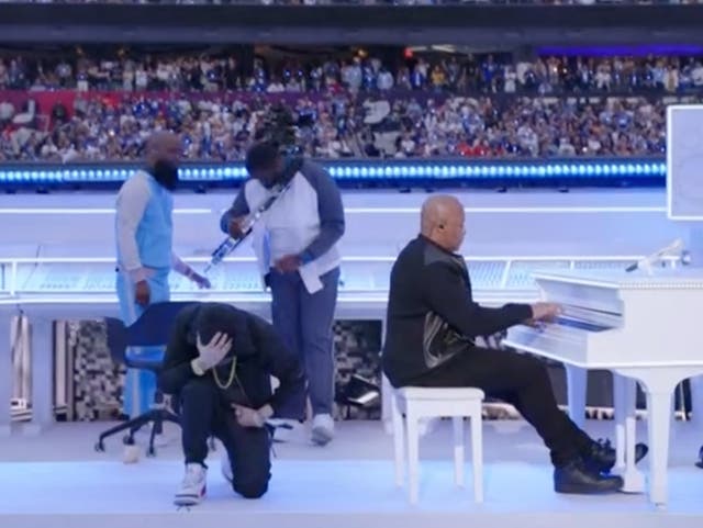 <p>Eminem kneeling at the end of his Super Bowl halftime show performance</p>