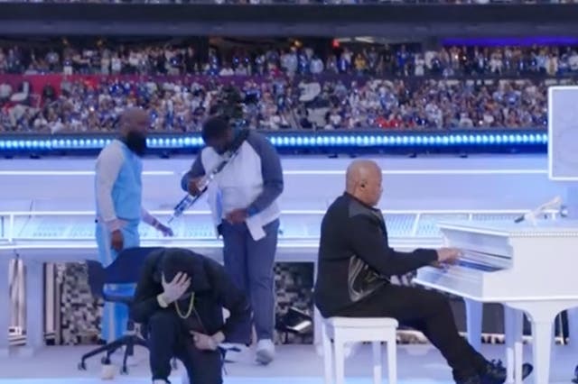 <p>Eminem kneeling at the end of his Super Bowl halftime show performance</p>