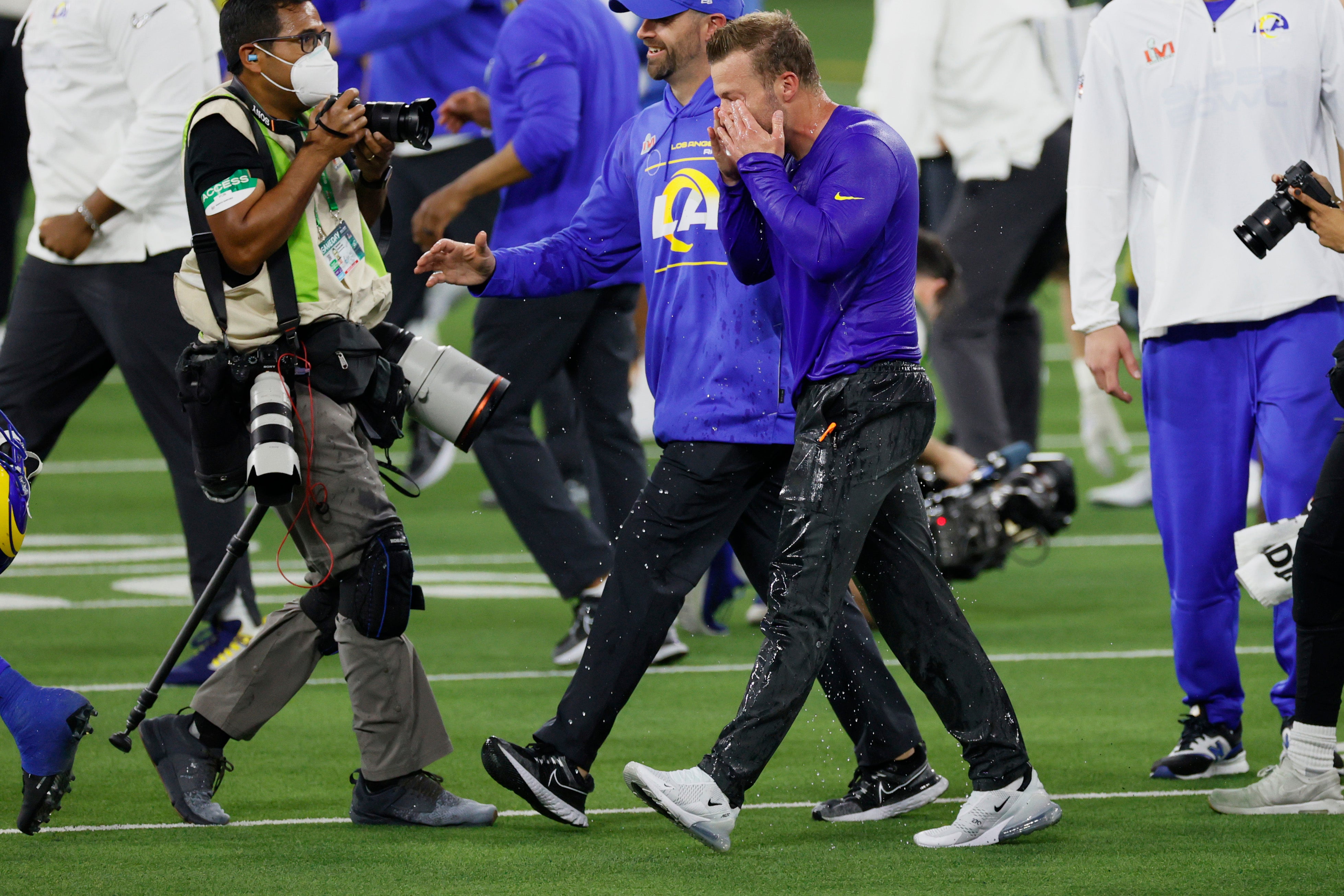 A drenched Sean McVay rubs his eyes in disbelief