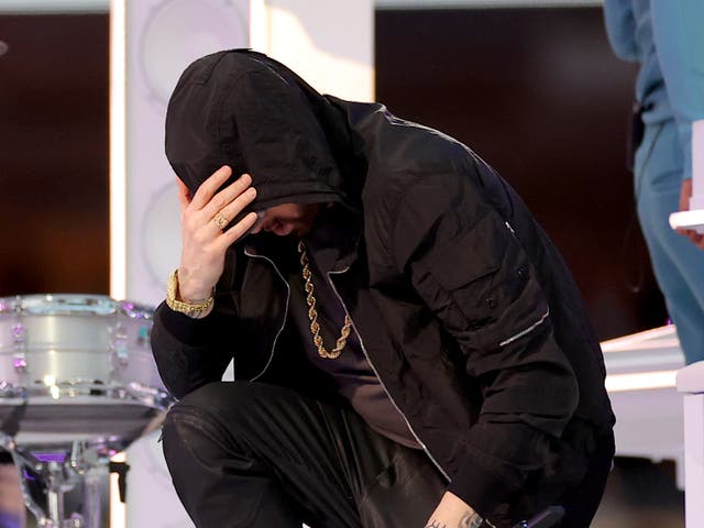 <p>Eminem kneels during his Super Bowl LVI Halftime Show performance</p>