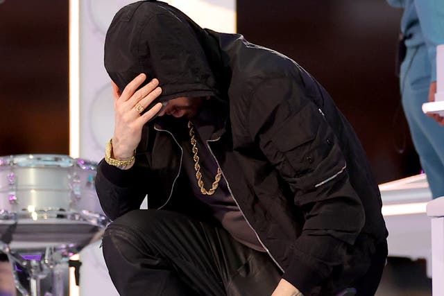 <p>Eminem kneels during his Super Bowl LVI Halftime Show performance</p>