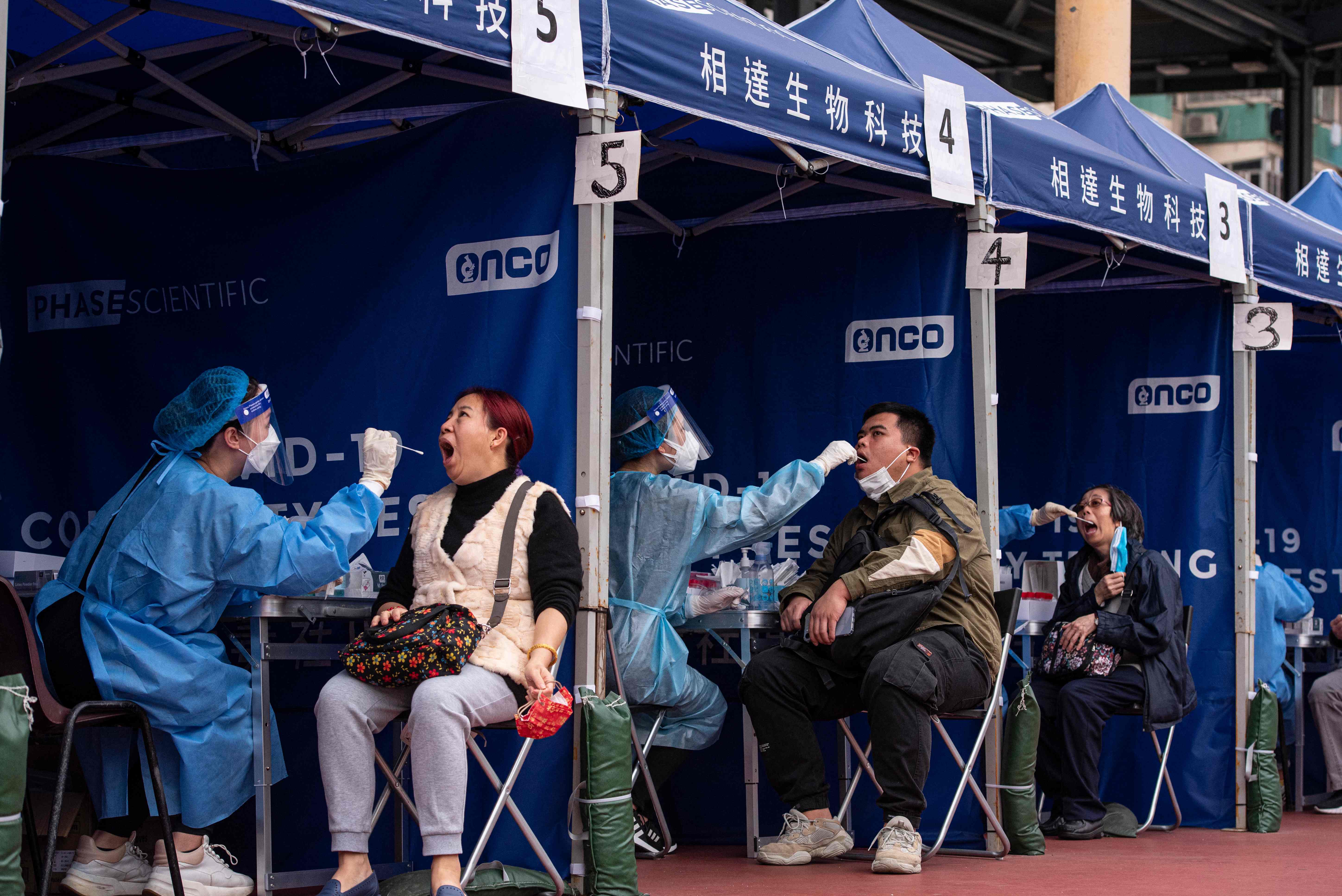 People are tested at a temporary testing site for Covid-19 in Hong Kong on February 12, 2022
