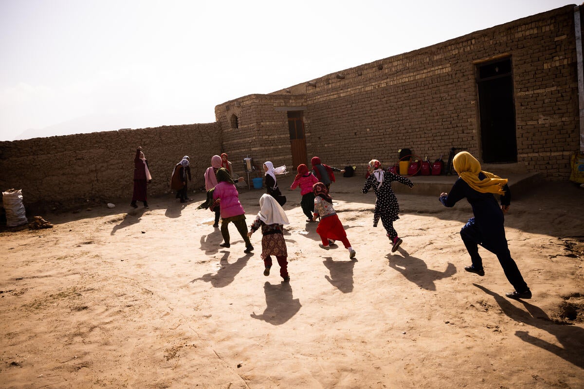 Girls playing outside their classroom in Blakh Province