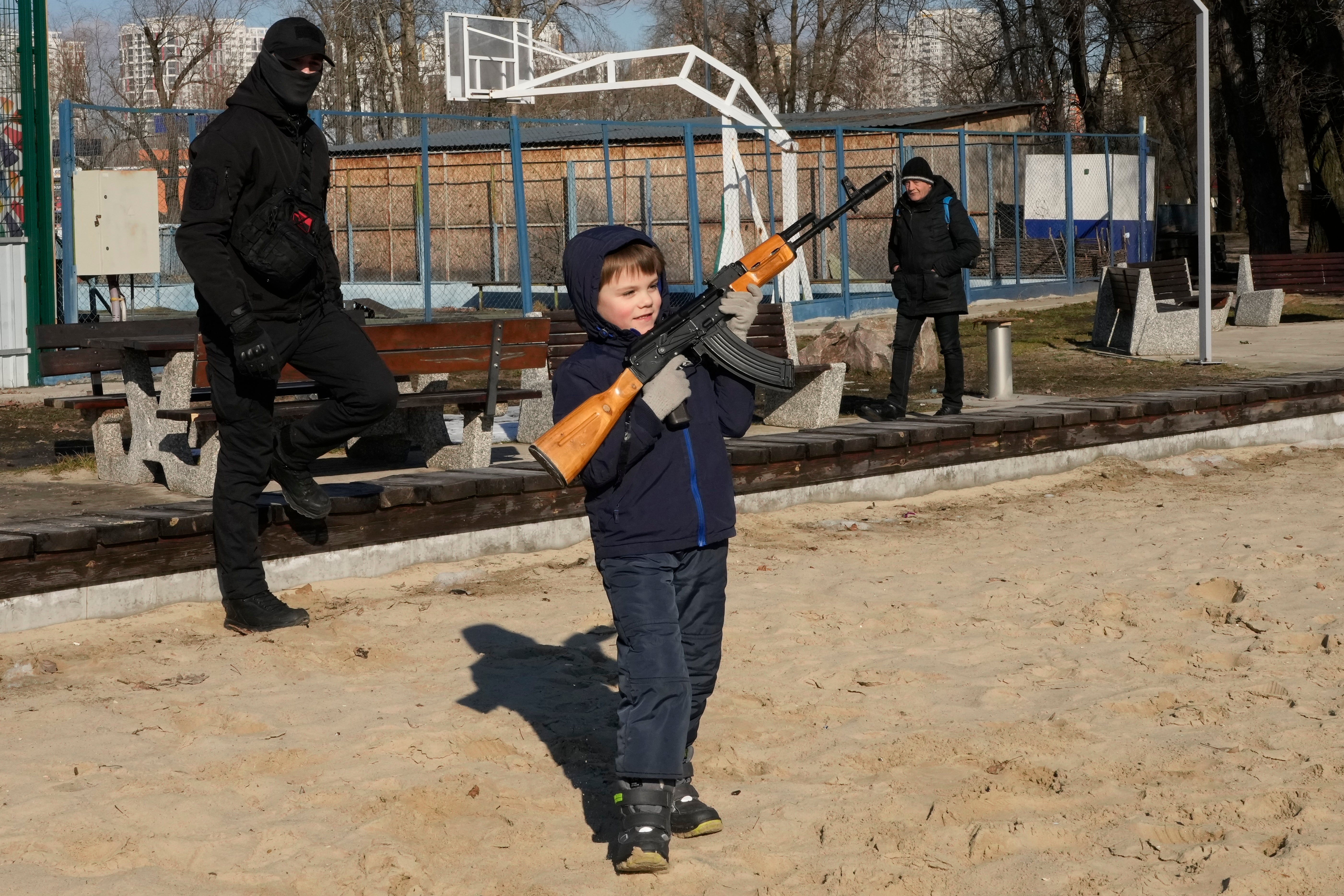 This little boy was seen holding a Kalashnikov