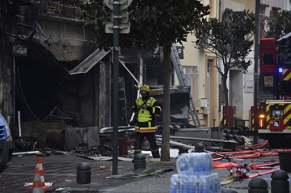 <p>A rescue worker near to the debris and burned houses after an explosion in Saint-Laurent-de-la-Salaque</p>