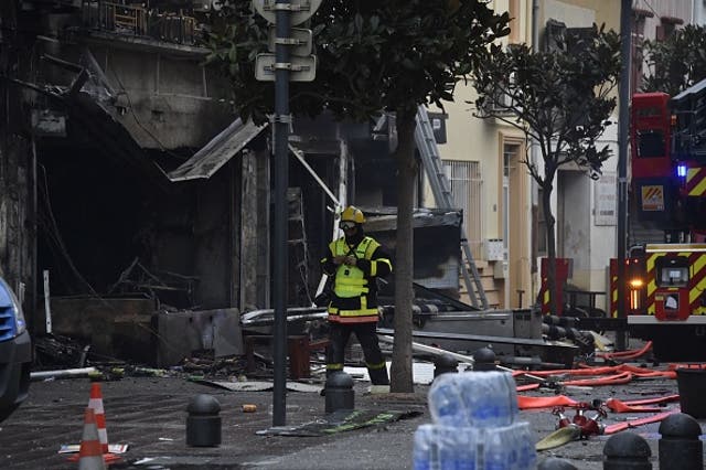 <p>A rescue worker near to the debris and burned houses after an explosion in Saint-Laurent-de-la-Salaque</p>