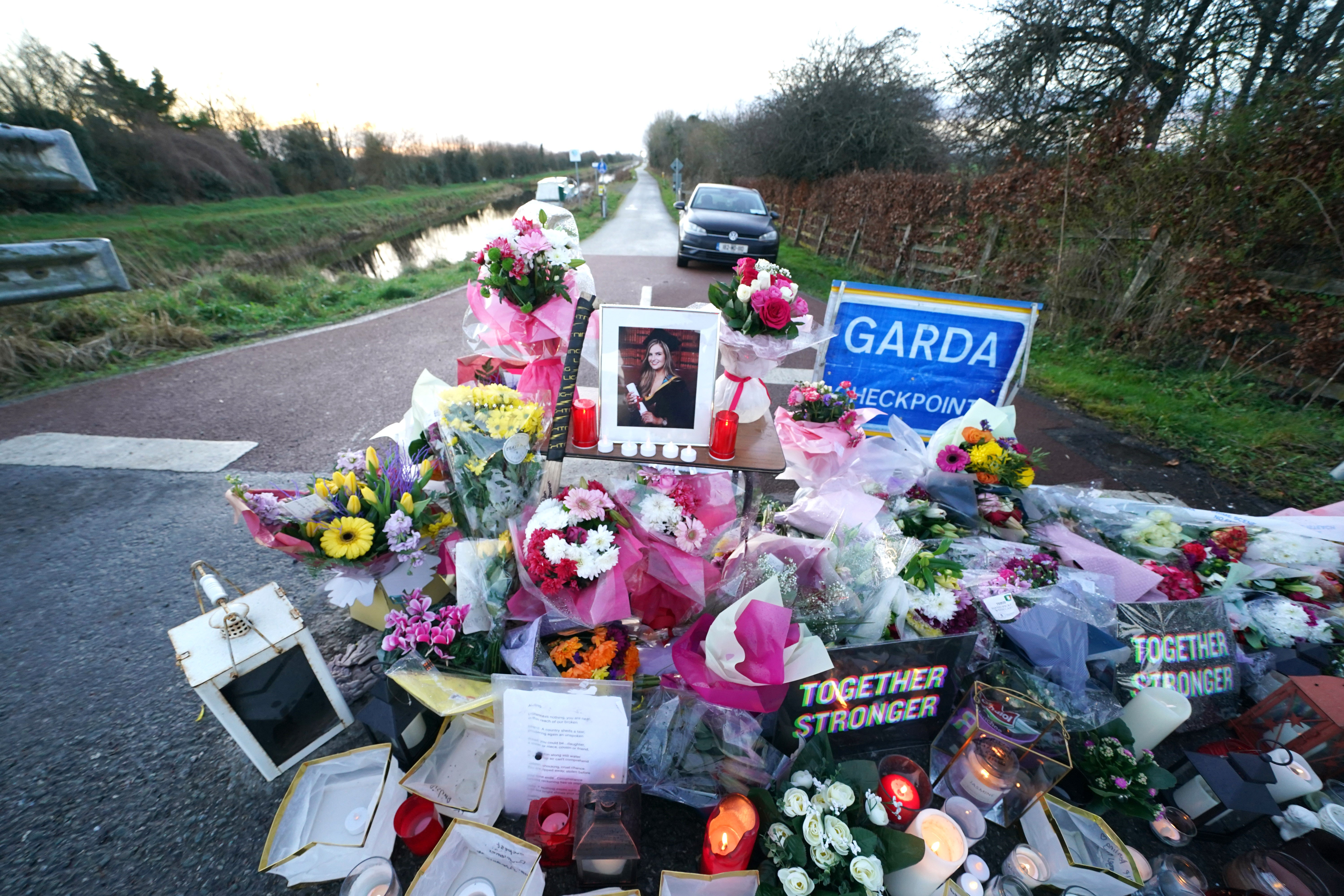 Floral tributes laid at the Grand Canal in Tullamore, Co Offaly, where primary school teacher Ashling Murphy was found dead after going for a run (Brian Lawless/PA)