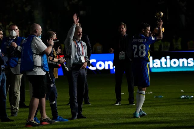 Roman Abramovich, centre, celebrates on the pitch as Chelsea captain Cesar Azpilicueta raises the Club World Cup (Hassan Ammar/AP)