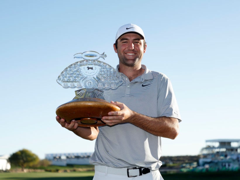 Scottie Scheffler poses with the trophy after winning the WM Phoenix Open