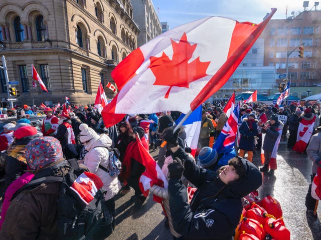 <p>Protesters waived flags in downtown Ottawa as an anti-Covid mandate protest continued</p>