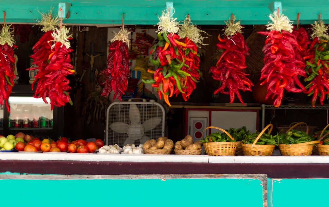 Red chilli ristras hung at roadside stand,