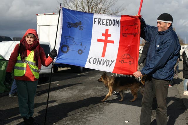 <p>Demonstrators protesting against Covid restrictions as part of ‘European Freedom Convoy 2022’ wait in a car park in Brussels</p>