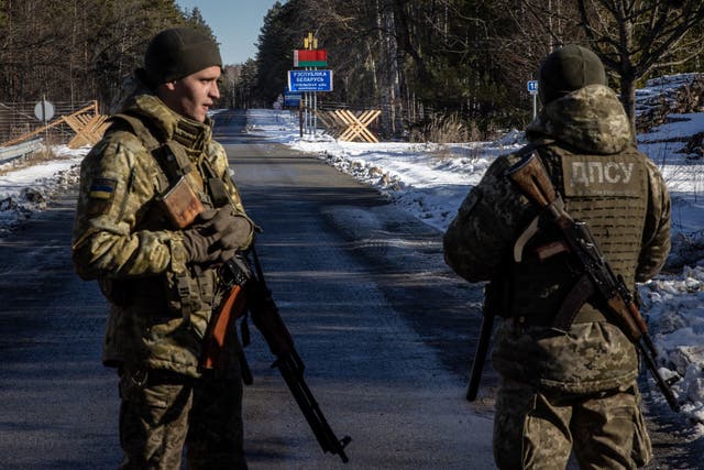 <p>Members of the Ukrainian State Border Guard stand watch at the border crossing between Ukraine and Belarus on 13 February in Vilcha, Ukraine</p>