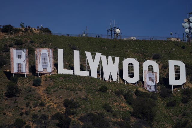 <p>Workers transform the Hollywood sign to read "Rams House" in Los Angeles on Monday, Feb. 14, 2022. The Hollywood Chamber of Commerce and the Hollywood Sign Trust allowed for making the change to celebrate the Los Angeles Rams' Super Bowl championship.</p>