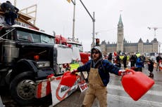 Canada trucker protest - live: Ottawa convoy defiant as banks, police, class-action suit pile on pressure