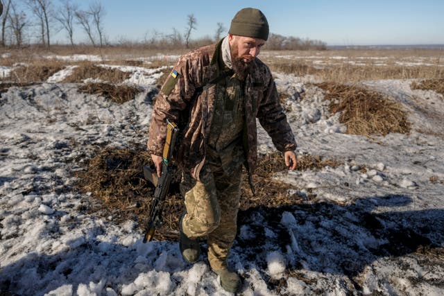 A Ukrainian serviceman walks on a front line position outside Popasna, Luhansk region, eastern Ukraine (AP)