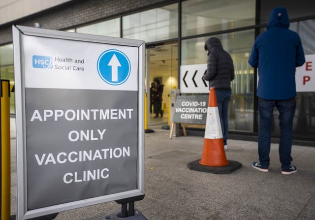 People queuing at a Covid-19 vaccination centre (Liam McBurney/PA)