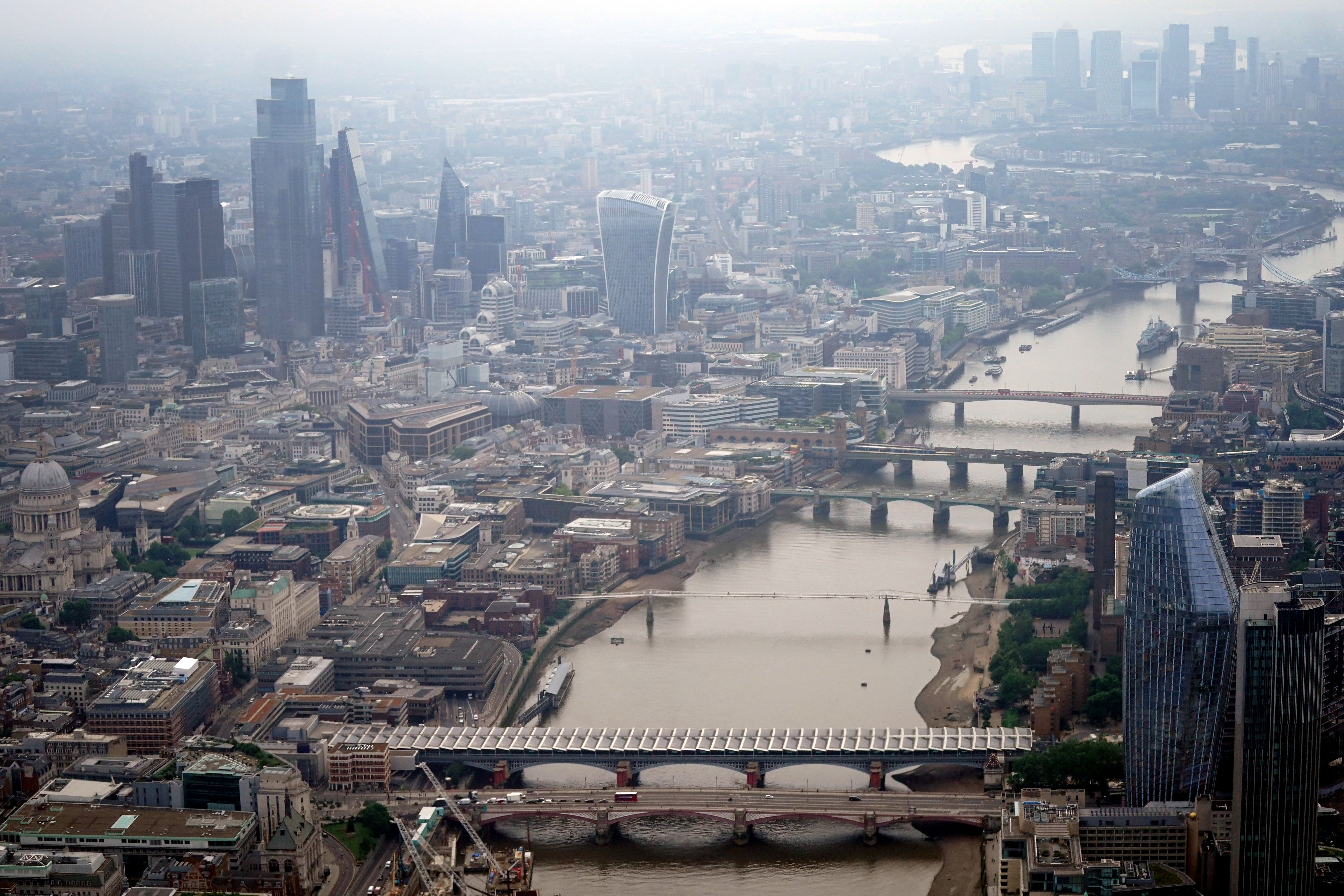 An aerial view of the River Thames in central London alongside the City of London and Canary Wharf financial districts. Picture date: Friday July 9, 2021.