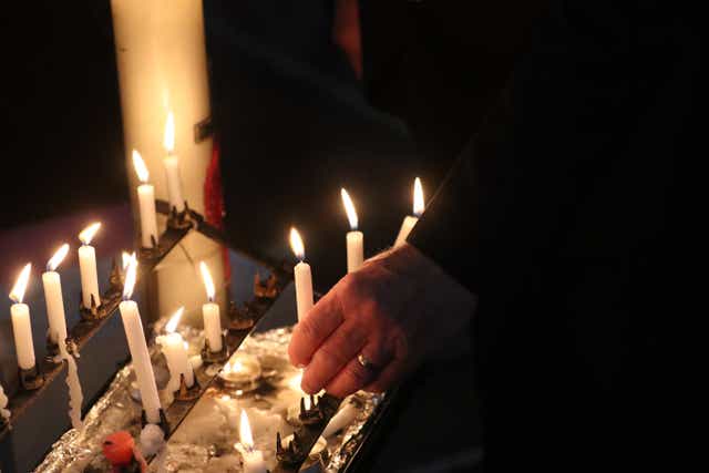 Lit candles in a church. File image (Steve Parsons/PA)